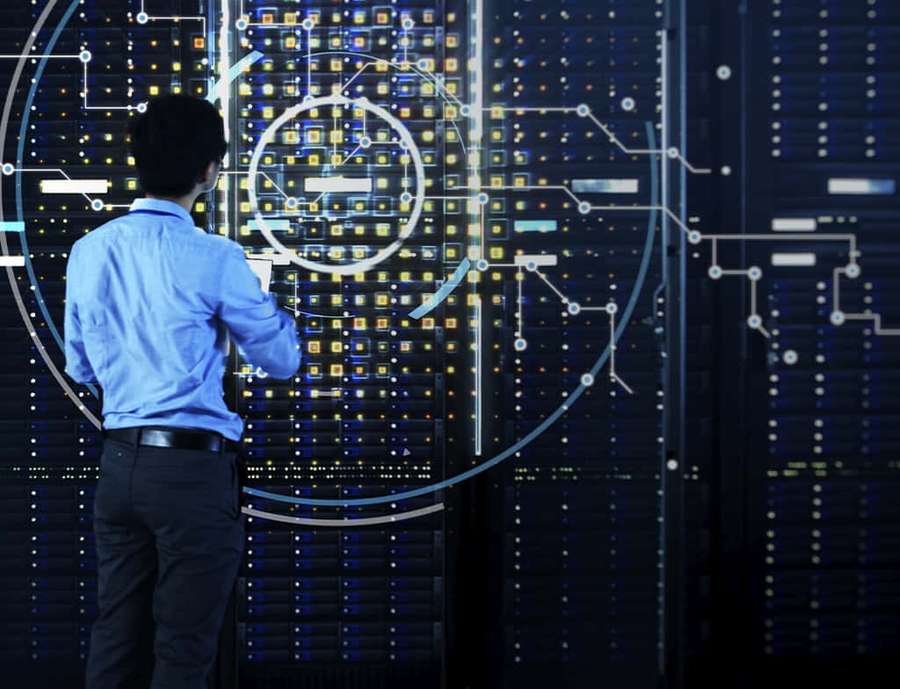 Man in blue shirt interacting with digital interface in server room. — Data Background
