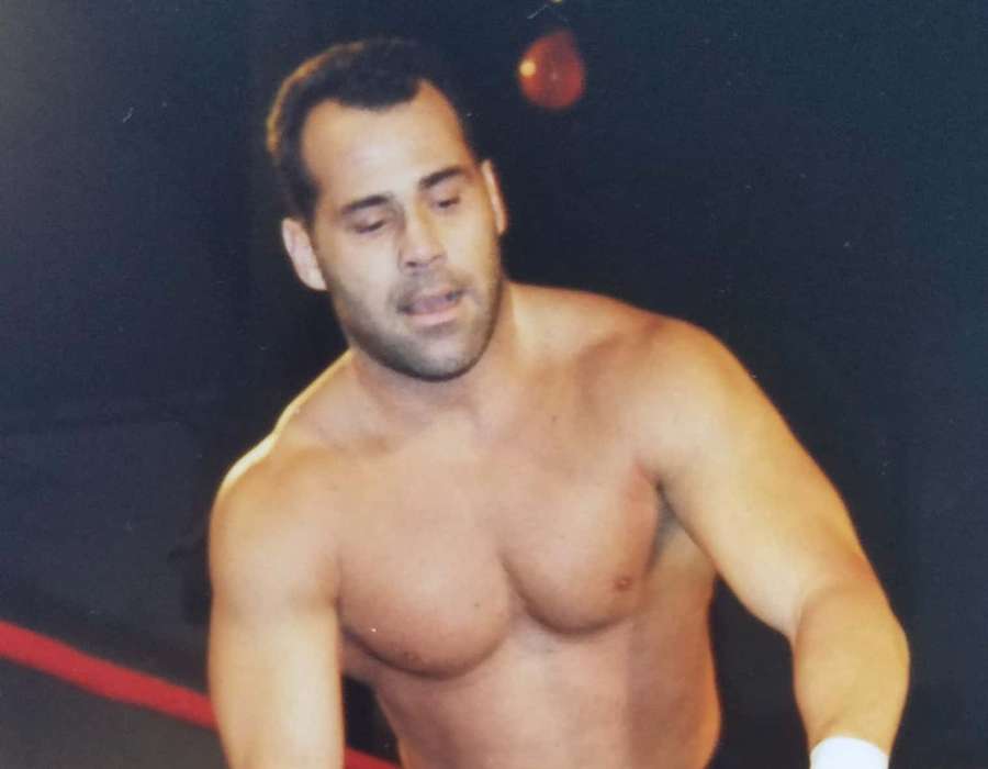 A muscular wrestler in a ring during a performance. — Dean Malenko Wallpaper