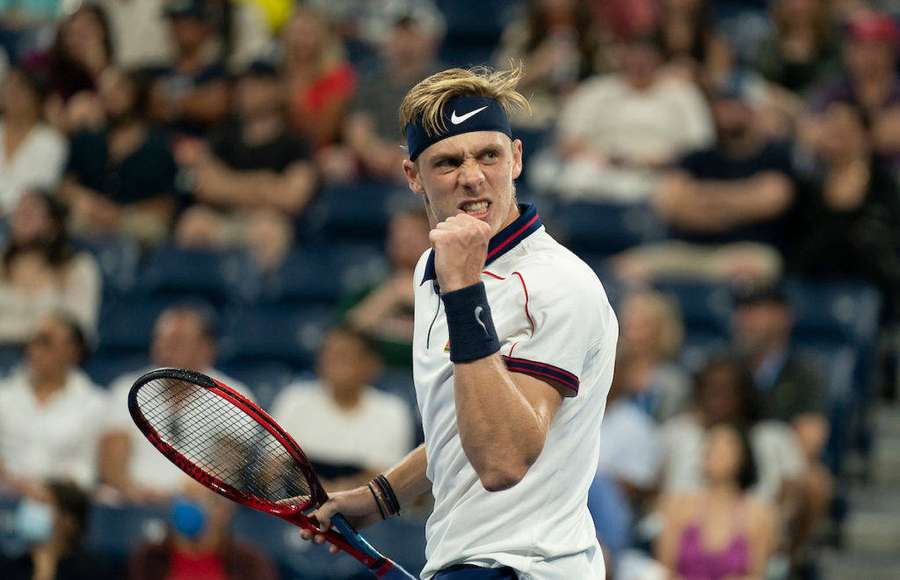 Tennis player celebrating victory with clenched fist on court — Denis Shapovalov Wallpaper