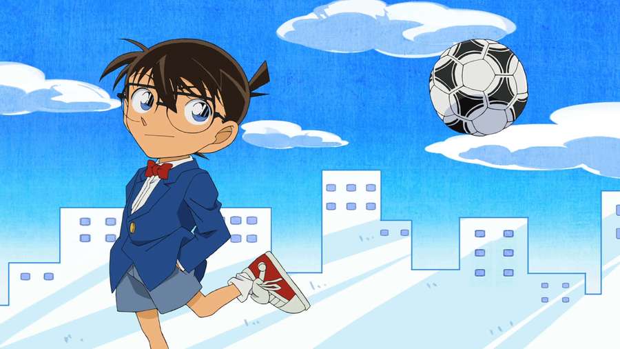 Anime boy kicking soccer ball in cityscape under blue sky with clouds. — Detective Conan Background