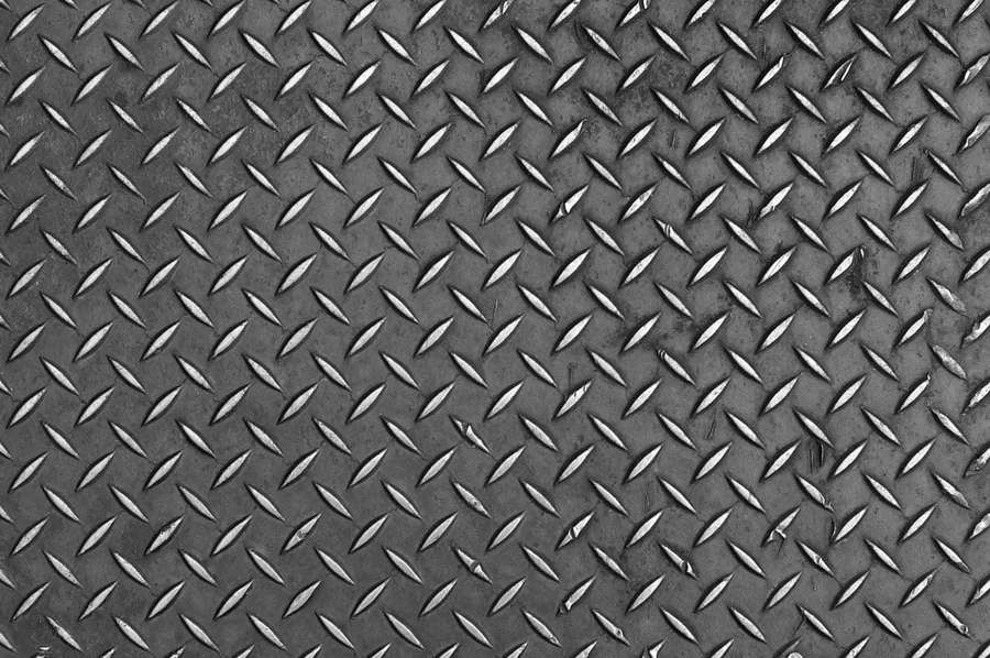 Diamond plate metal texture with raised diamond pattern and surface wear. — Diamond Plate Background