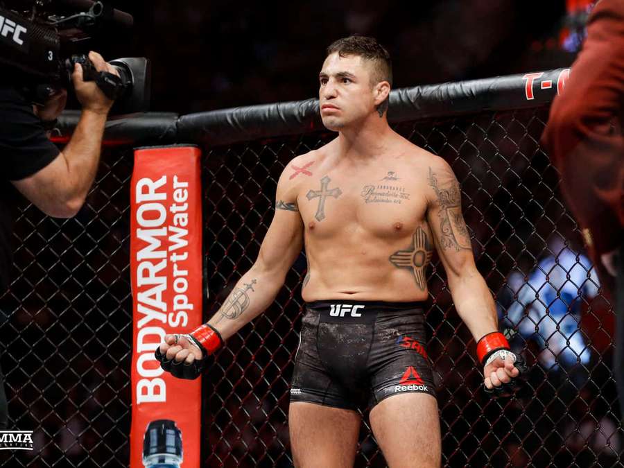 MMA fighter with tattoos standing in octagon cage during fight event. — Diego Sanchez Wallpaper