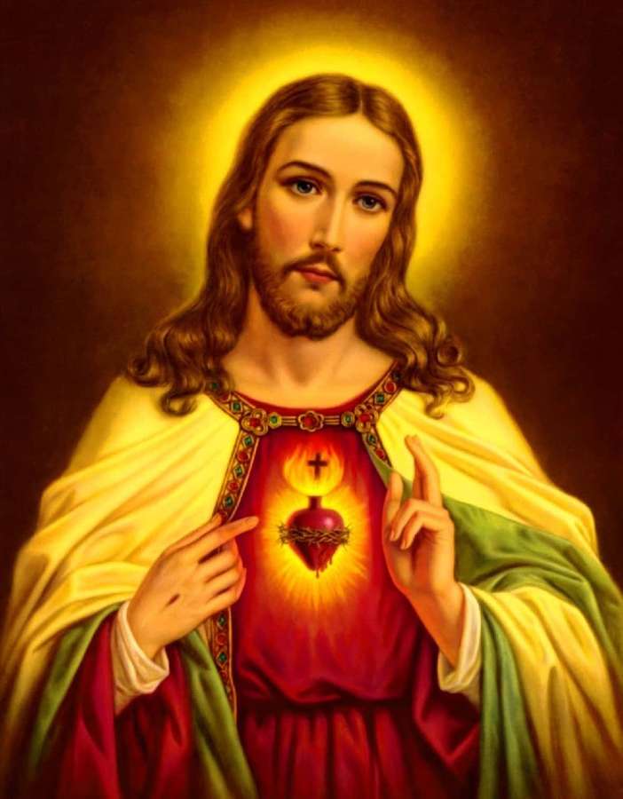 Jesucristo señalando su corazón sagrado con un halo brillante. — Dios Jesús Fondos de pantalla