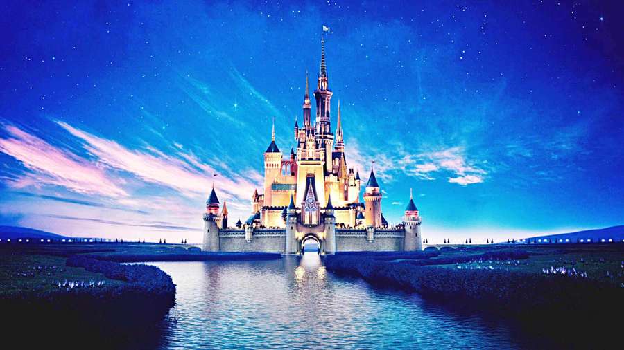 A glowing castle on water under a starry twilight sky with pink clouds. — Disneyland Background