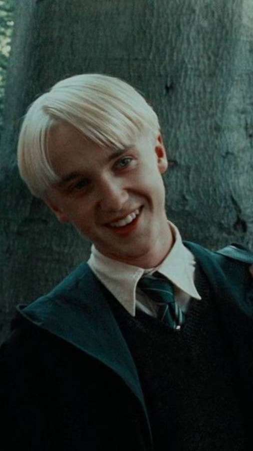 Young man with blonde hair smiling in forest wearing school uniform — Draco Background