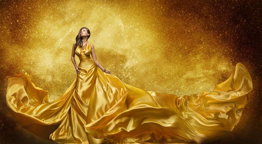 Woman in golden gown floating in glittering cosmic space. — Dress Wallpaper