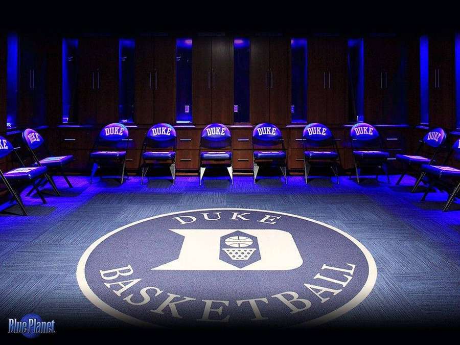 Duke basketball team locker room with blue lighting and team logo on floor. — Duke University Wallpaper