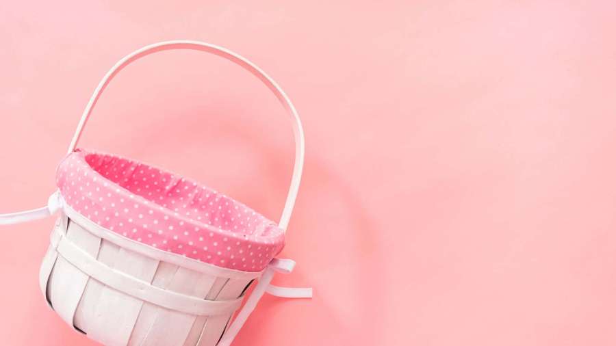 White woven basket with pink polka dot lining on pink background — Easter Basket Wallpaper