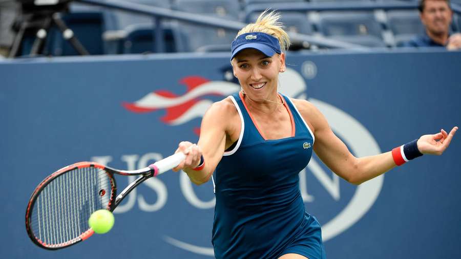 Female tennis player hitting a ball with a racket on a court. — Elena Vesnina Wallpaper