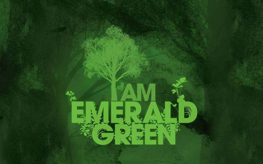 A glowing emerald green tree with text I AM EMERALD GREEN in a dark forest. — Emerald Background