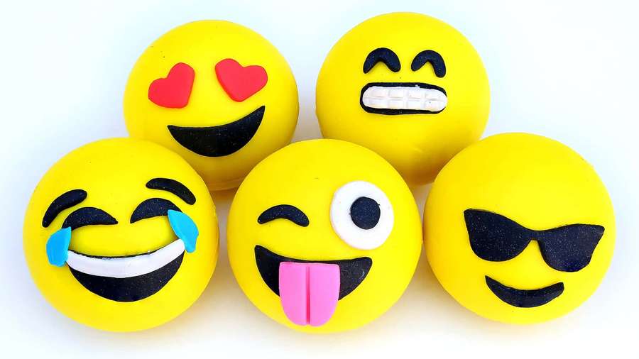 Five colorful emoji figurines with funny faces on a white background. — Emoji Background