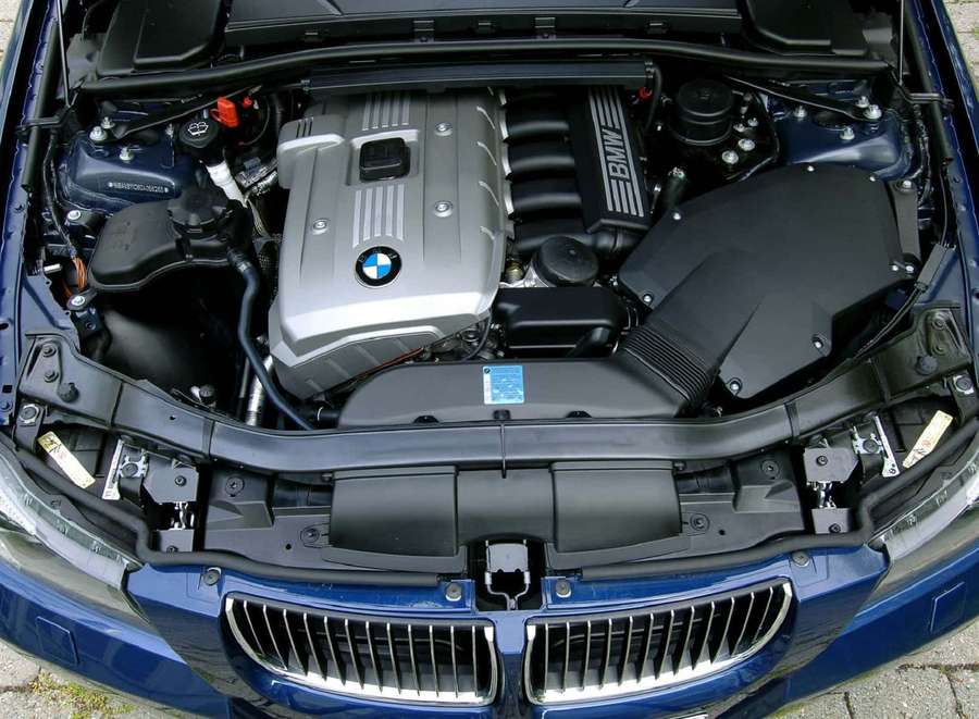 Blue BMW car with open hood showing engine compartment. — Engine Picture