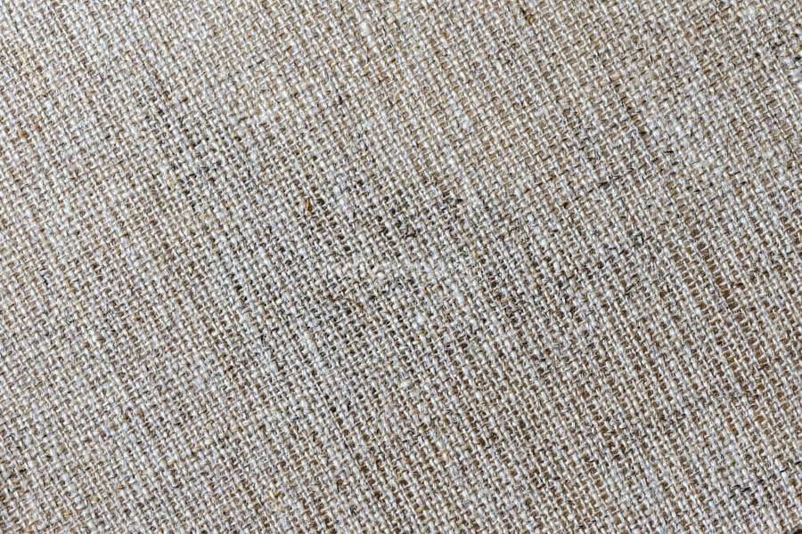 Close-up of beige linen fabric showing woven texture and natural fibers. — Fabric Texture Wallpaper