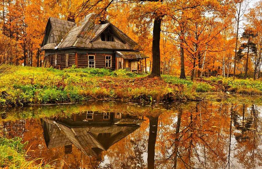 Rustic cabin in autumn forest reflected in calm pond — Fall Cabin Wallpaper
