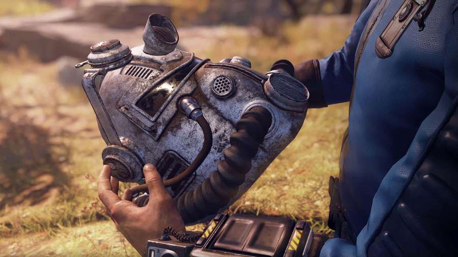 Person holding a rusty gas mask in a grassy field — Fallout 76 Background