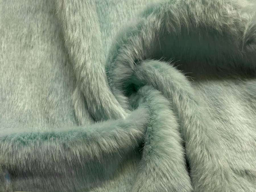 Close-up of mint green faux fur fabric with soft fluffy texture. — Faux Fur Wallpaper