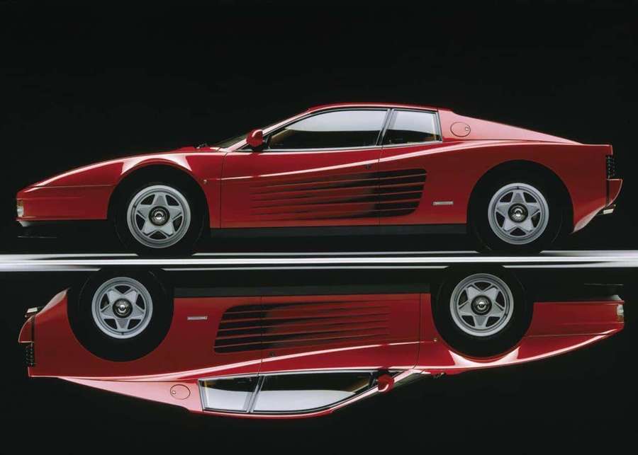 Red Ferrari Testarossa sports car with mirror reflection on black surface. — Ferrari Testarossa Wallpaper