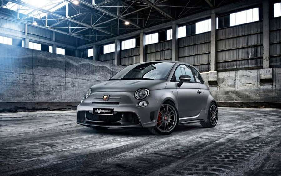 Matte gray Fiat 500 Abarth sports car in an industrial warehouse with concrete floors and high ceilings. — Fiat 500 Wallpaper