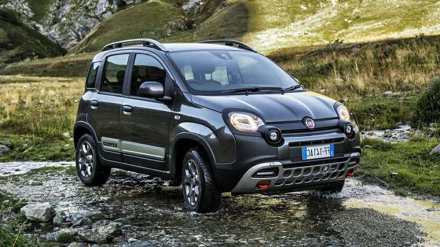 Mørkegrå Fiat Panda Cross kører gennem en lavvandet stenet strøm i et bjergområde. — Fiat Panda Wallpapers