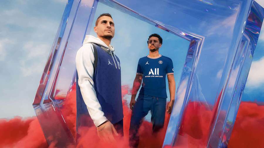 Two athletes in branded sportswear inside a floating transparent cube with red smoke and sky background. — Fifa 22 Wallpaper