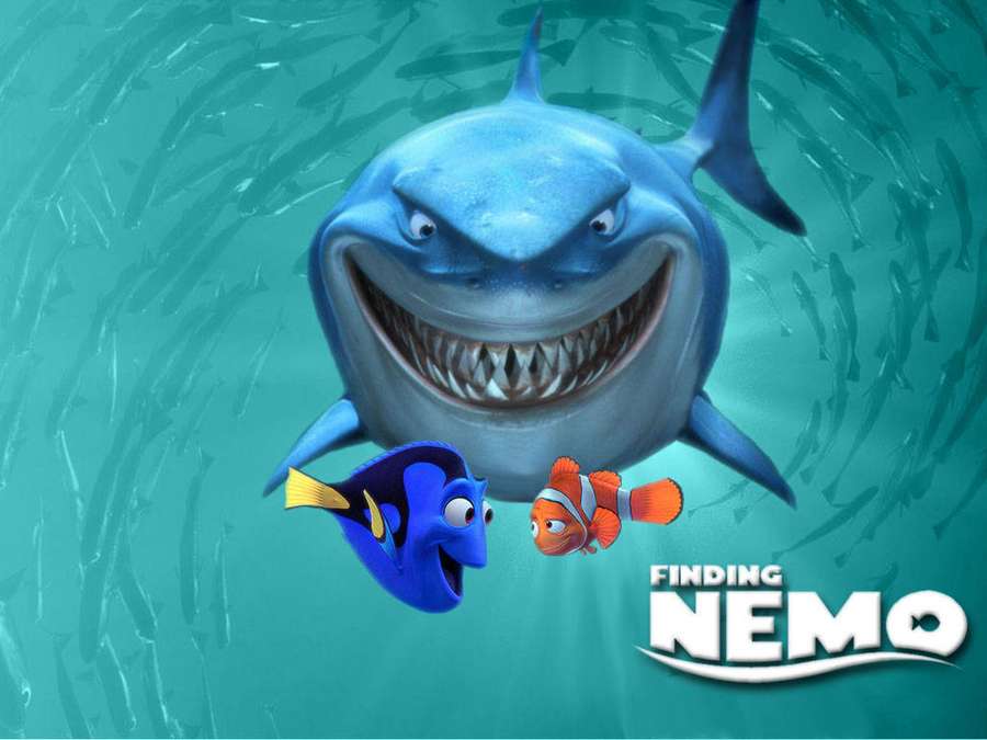 A large shark with a wide grin looms over two small fish in a school of fish underwater. — Finding Nemo Picture