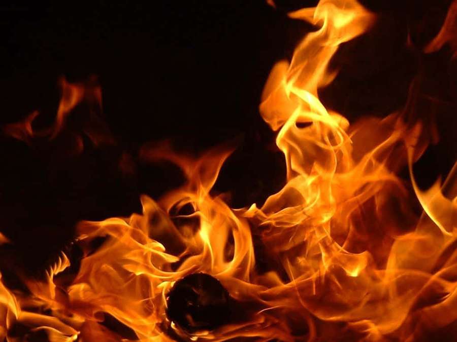 Close-up of bright orange and yellow flames against a black background. — Flame Picture