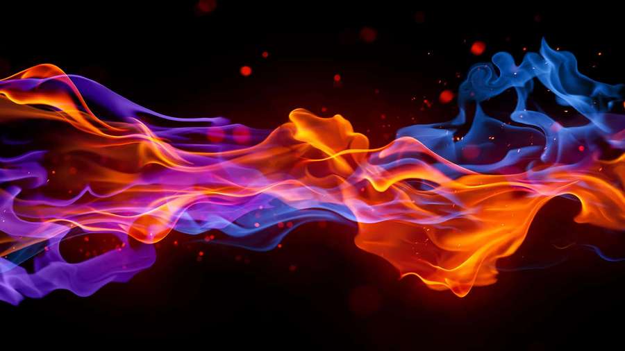 Dynamic colorful flames in orange and blue against a dark background. — Flames Background