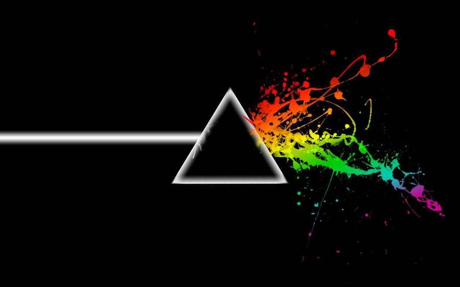 White light beam splits into rainbow paint splatters through a prism on black background. — Floyd Wallpaper