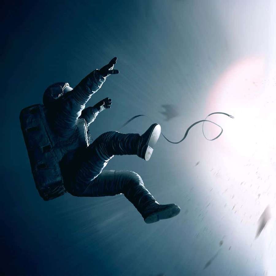 Astronaut floating in space with sun behind and tether trailing — Forgotten Wallpaper