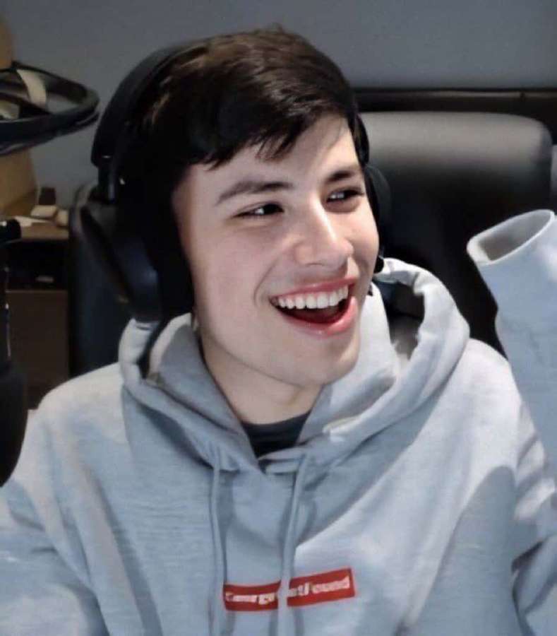 Joven gamer riendo con auriculares en una configuración de streaming. — Georgenotfound Fondos de pantalla