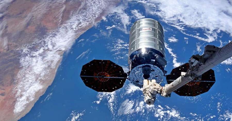 Satellite in orbit above Earth showing clouds oceans and land — Geostar Wallpaper