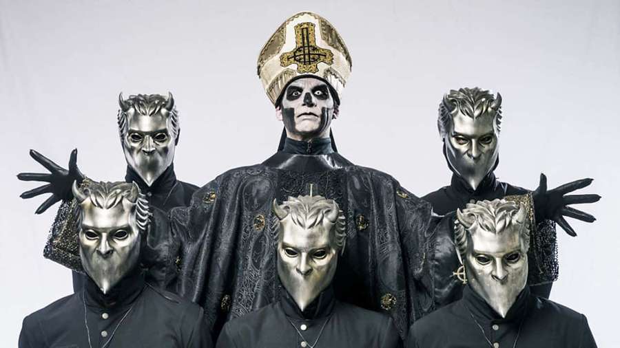 Six masked figures in black robes and silver masks, one wearing a bishop's mitre, posing in a studio. — Ghost Band Wallpaper