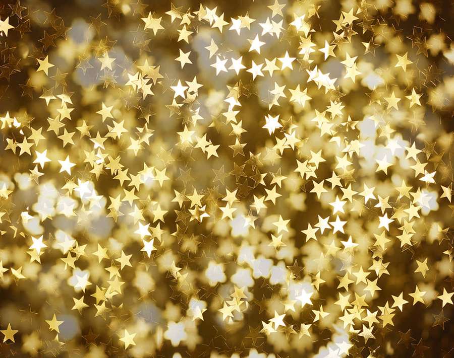 Golden star-shaped lights shimmering with soft bokeh in a festive background. — Gold Stars Wallpaper