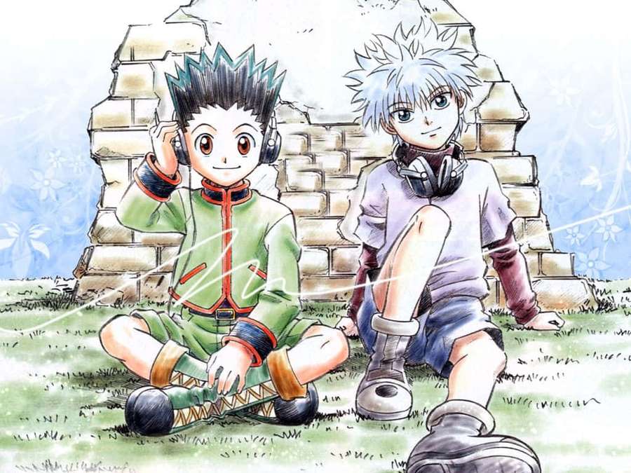 Two anime boys with headphones sitting on grass near a stone ruin. — Gon Killua Wallpaper