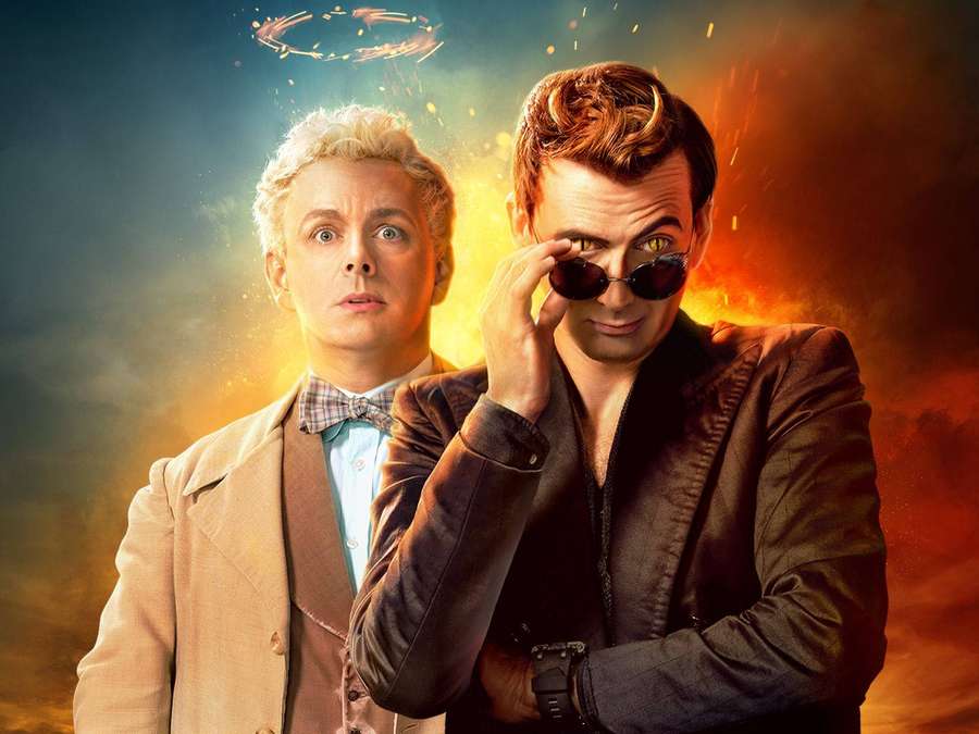 Two men in vintage outfits against a fiery cosmic background with a glowing ring. — Good Omens Wallpaper