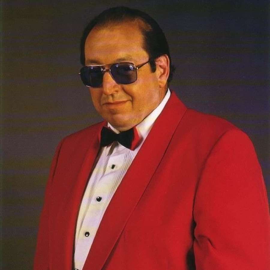 Man in red tuxedo and sunglasses smiling in studio portrait — Gorilla Monsoon Wallpaper