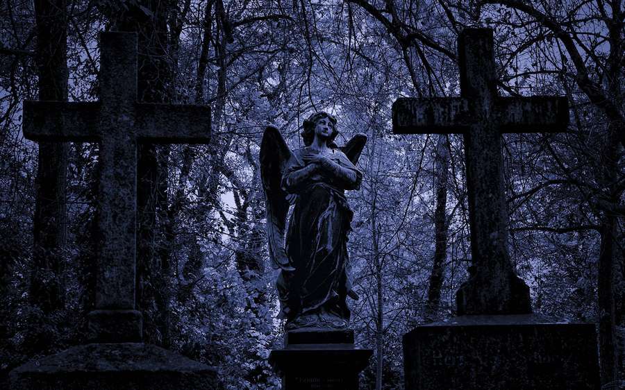 Angel statue flanked by crosses in a dark blue cemetery at night. — Graveyard Background