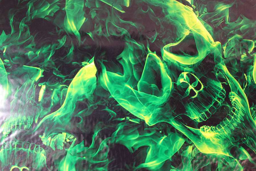 Glowing green skull surrounded by swirling flames on dark background — Green Fire Skull Wallpaper