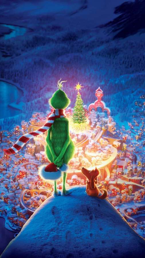 Der Grinch und sein Hund beobachten eine festliche verschneite Stadt bei Nacht. — Grinch Wallpaper