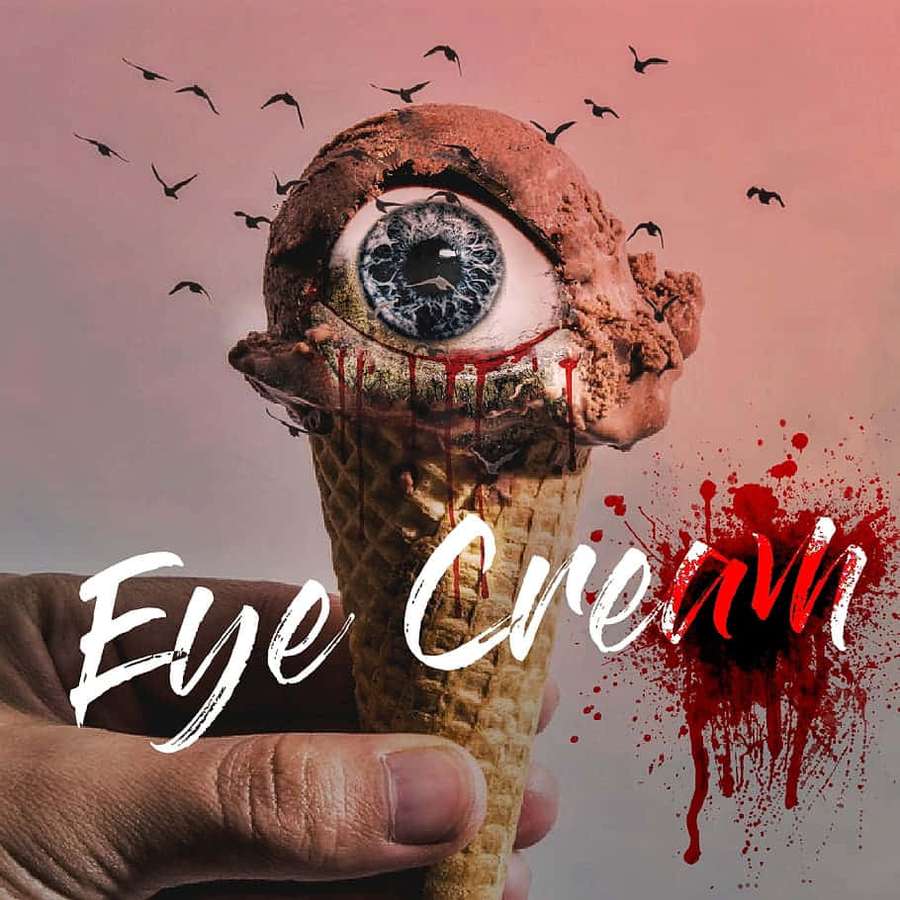 Hand holding ice cream cone with eyeball and blood splatter. — Grotesque Wallpaper