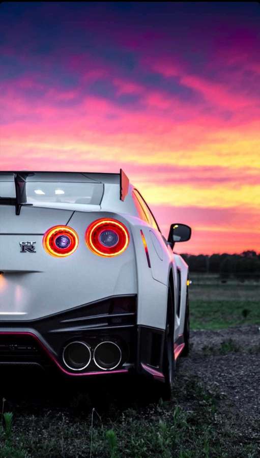 White sports car with glowing taillights parked at sunset. — Gtr iPhone Picture