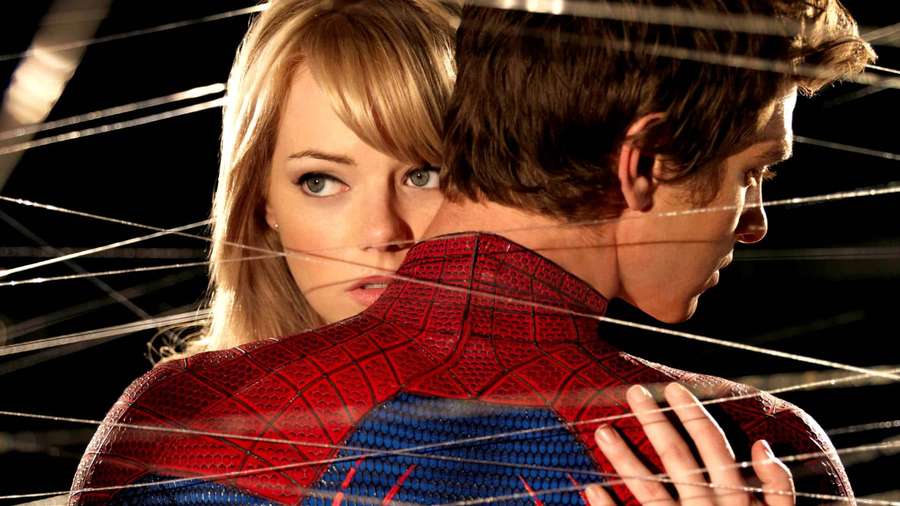 A woman looks over Spider-Man's shoulder through web lines in a dramatic scene. — Gwen Stacy Wallpaper