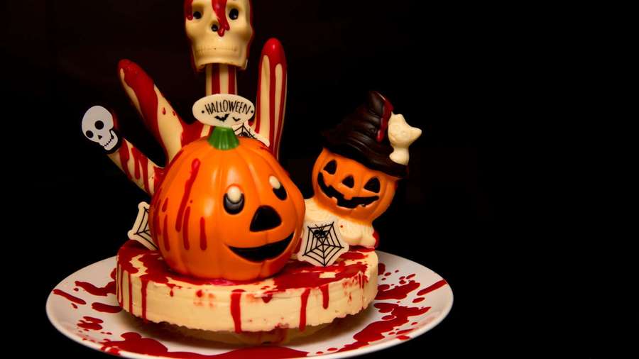 Halloween cheesecake with pumpkin skull decorations and fake blood splatter. — Halloween Cake Wallpaper