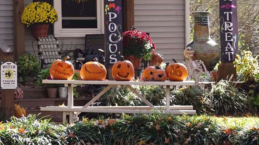 Halloween porch decorated with pumpkins signs and a skeleton. — Halloween Yard Decorations Wallpaper