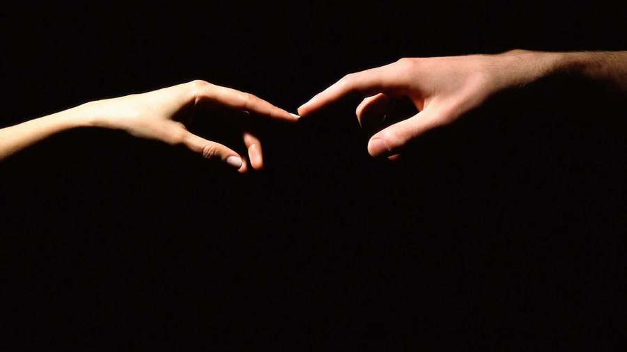 Two hands reaching toward each other in darkness with fingertips almost touching. — Hand Background