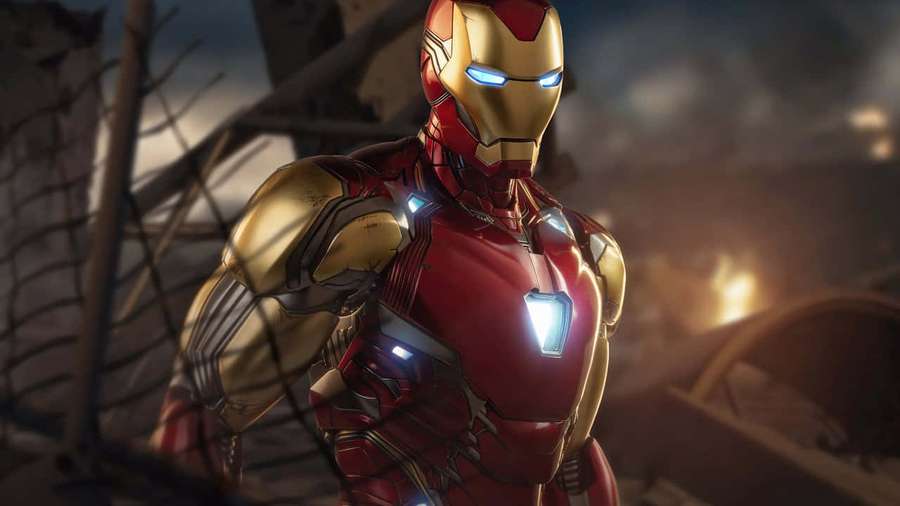 Iron Man in red gold armor stands amidst rubble with glowing eyes and chest arc reactor. — HD Picture