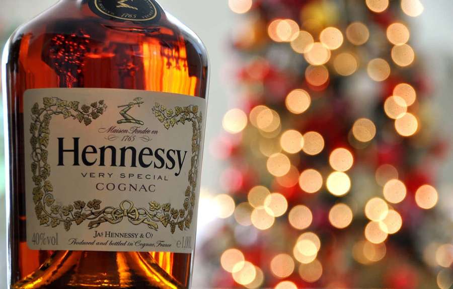 Hennessy cognac bottle with festive blurred lights behind. — Hennessy Wallpaper