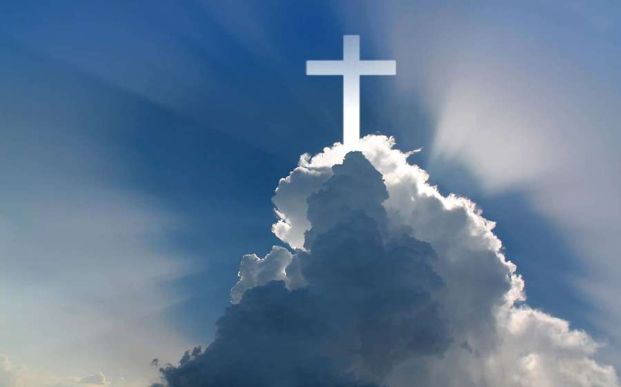 A glowing cross atop a cloud with sun rays shining through the blue sky. — Holy Background