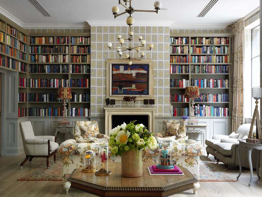 Classic library with bookshelves, fireplace, and floral furniture. — Home Library Wallpaper