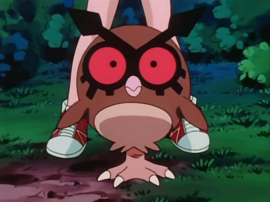 An anime owl Pokémon with red eyes and bunny ears wearing sneakers on grass. — Hoothoot Picture